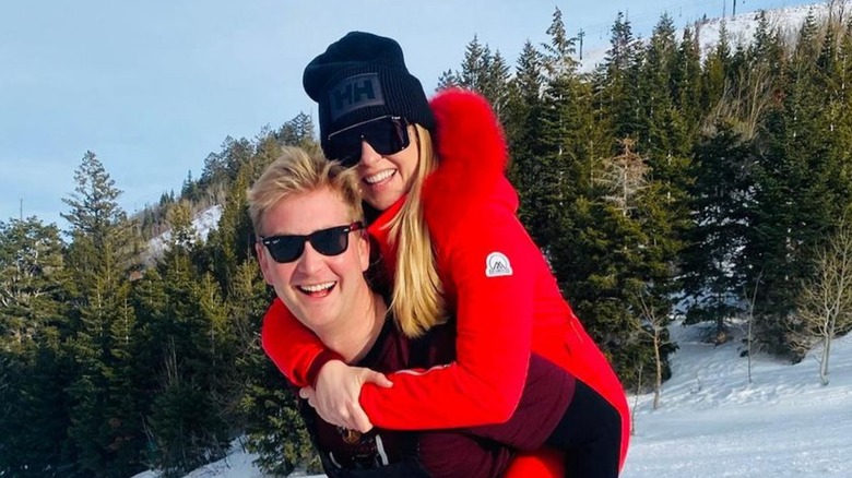 Peter Doocy holds Hillary Vaughn on back on snowy mountain