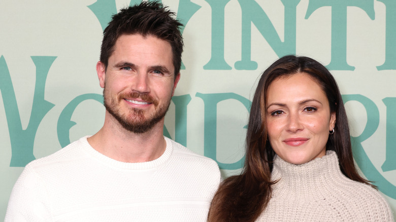 Robbie Amell and Italia Ricci smiling