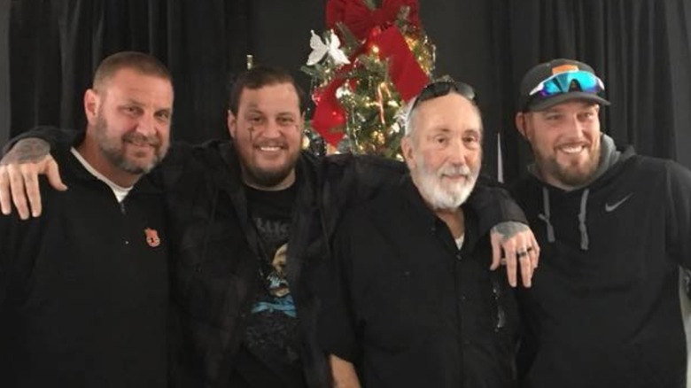 Jelly Roll posing with his father and brothers