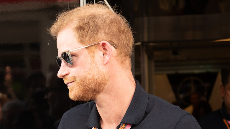 Prince Harry wearing dark sunglasses 