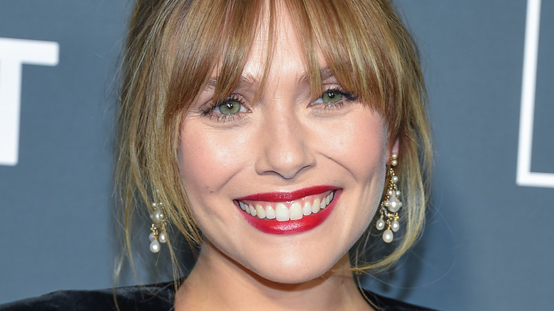 Elizabeth Olsen bottleneck bangs red lipstick