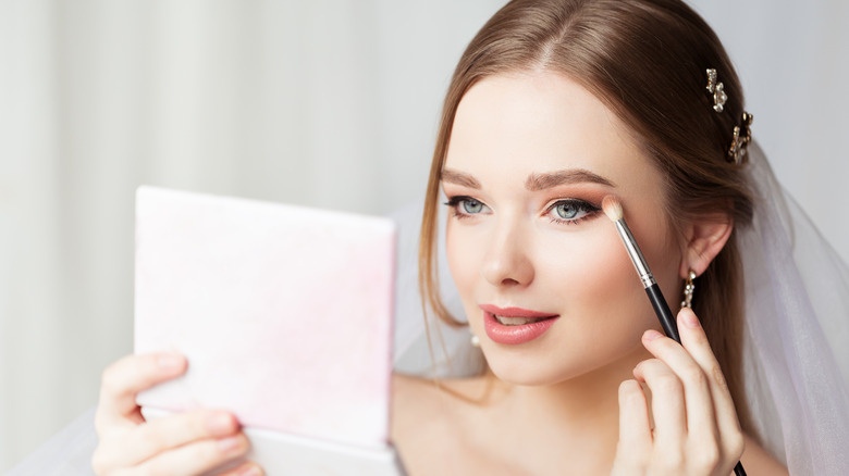 Bride doing own makeup 