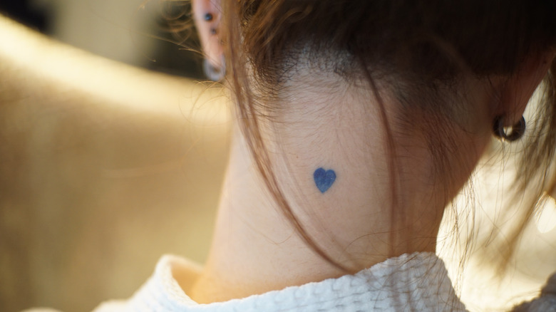 small heart tattoo on neck