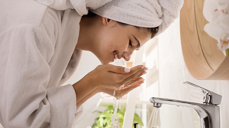 A woman washing her face