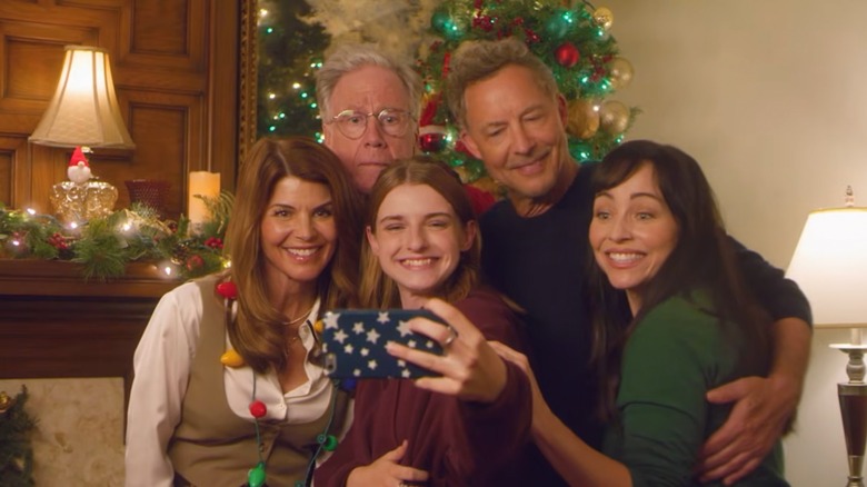 Lori Loughlin and Tom Cavanagh posing with 'What If Christmas' cast