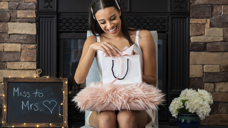 Bride opening gifts at shower