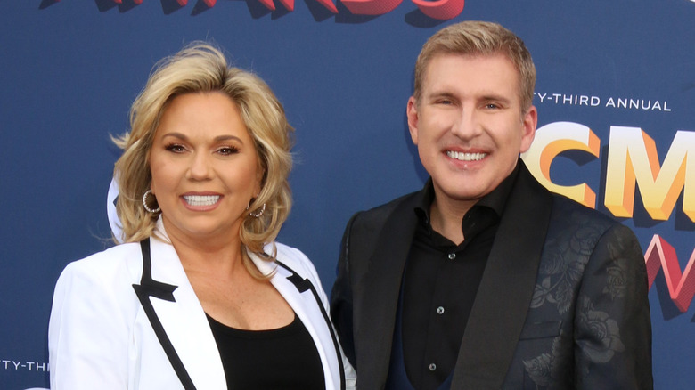 Julie and Todd Chrisley posing together at an event