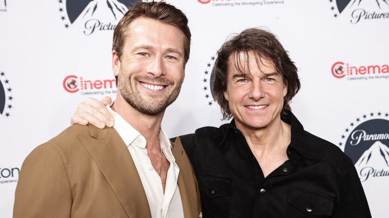Tom Cruise and Glen Powell smiling together at CinemaCon