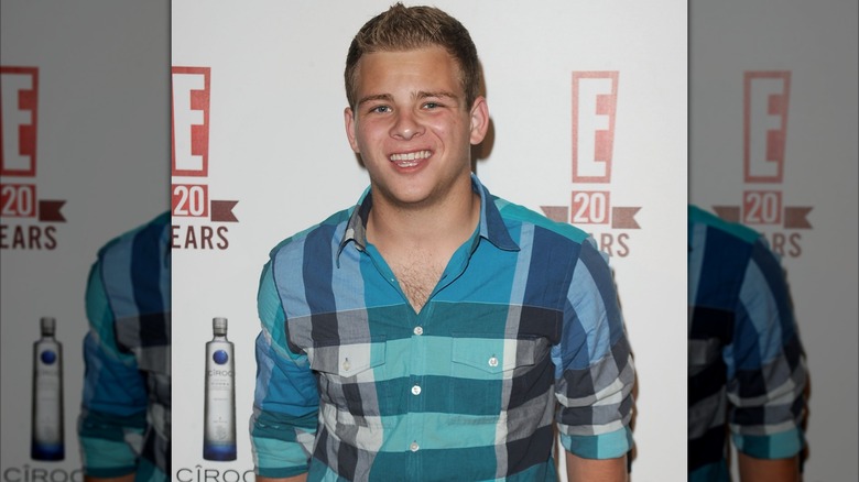 Jason Lipnicki smiling at an event for E!