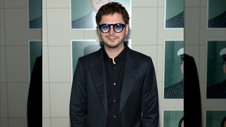 Michael Cera wearing sunglasses and smiling at a movie premiere