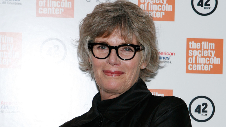 Kelly McGillis posing for the camera in thick black glasses at an event with the film society of Lincoln Center