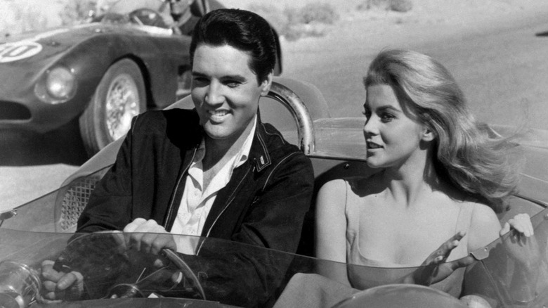 Still from Viva Las Vegas of Elvis Presley and Ann-Margret driving in a car together in black and white