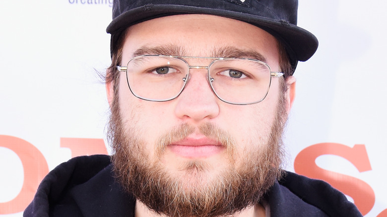 Angus T. Jones poses on the red carpet