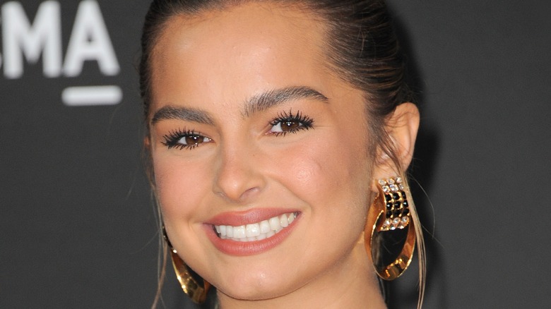 Addison Rae smiling with gold hoops at LACMA event 