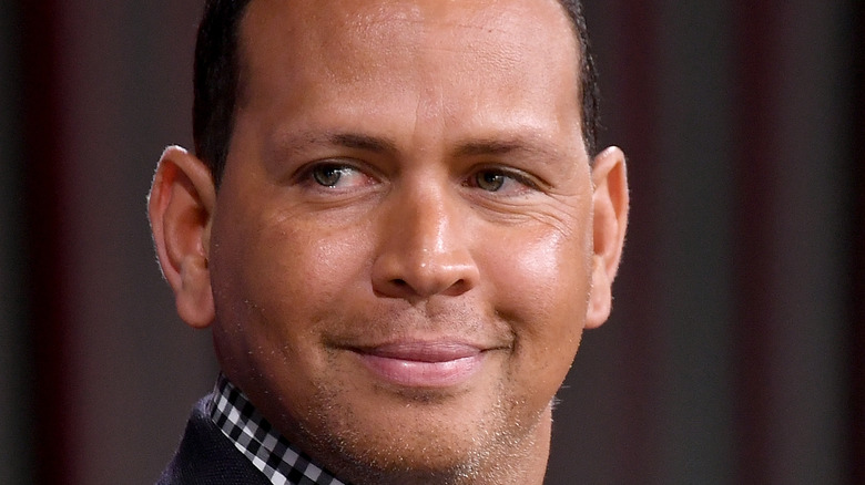 Alex Rodriguez smiles at an event.