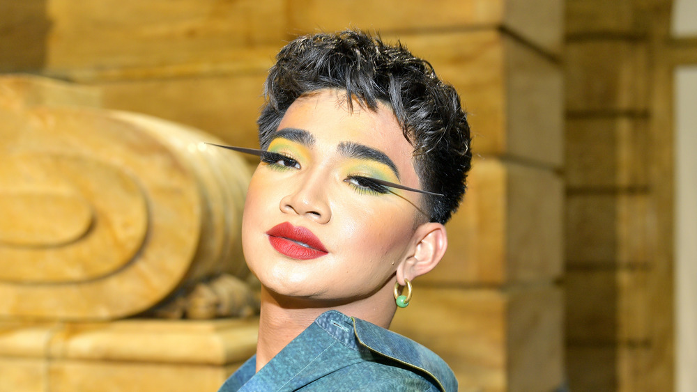 Bretman Rock, red lipstick, green/gold eye shadow