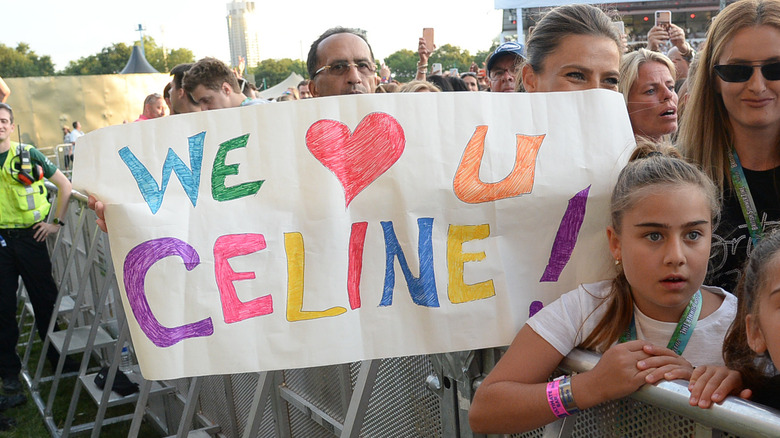Fan holding up a sign