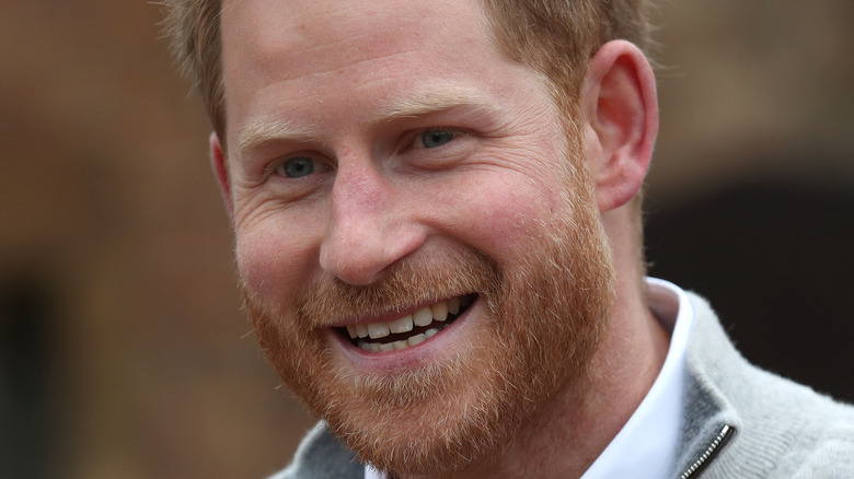 Prince Harry laughng at a royal event 