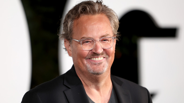 Matthew Perry smiling at event