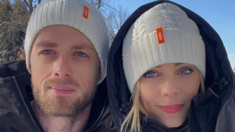 Laura Vandervoort and Adam Coates sitting together