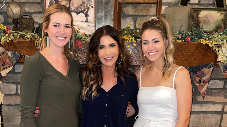 Kristi Noem smiling with her two daughters Kennedy and Kassidy