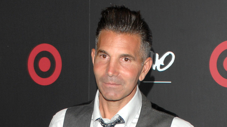 Mossimo Giannulli in front of black backdrop with Mossimo and Target logos