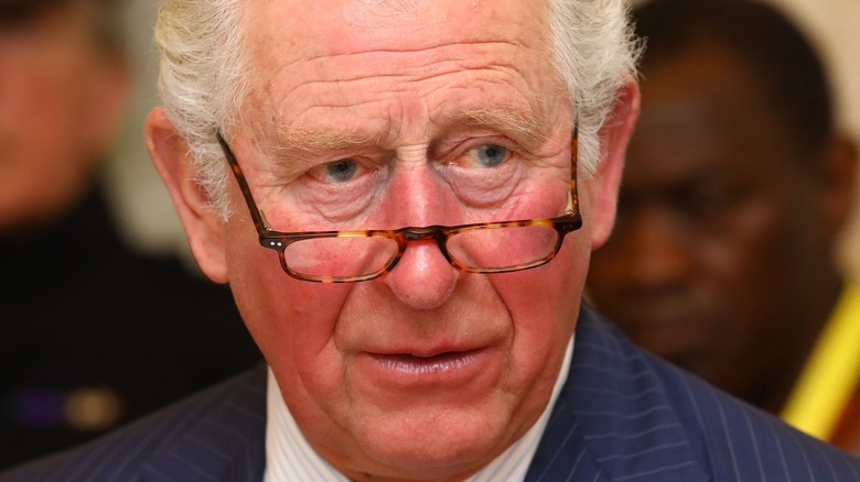 Prince Charles looks thoughtful in glasses