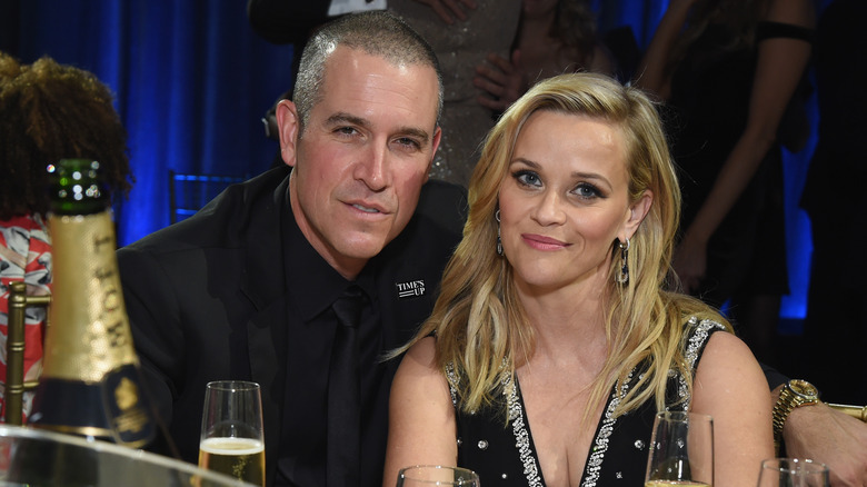 Reese Witherspoon posing with Jim Toth at an event