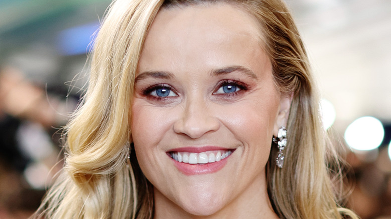 A close up of Reese Witherspoon wearing diamond earrings