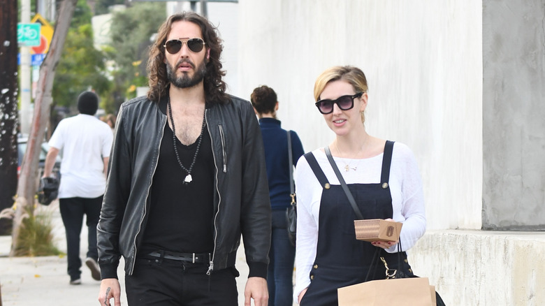 Russell Brand and his wife Laura walking outside