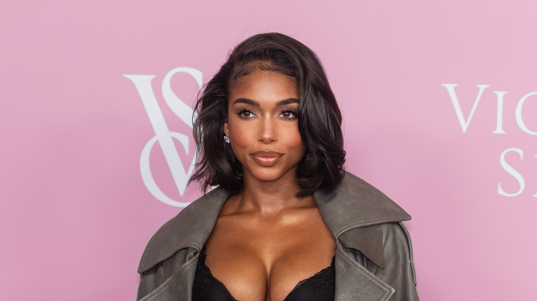 lori harvey poses on red carpet