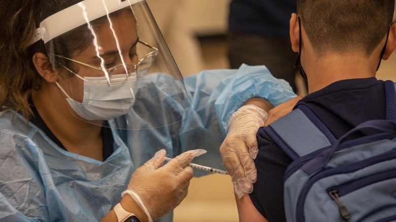 Medical worker administering the COVID vaccine