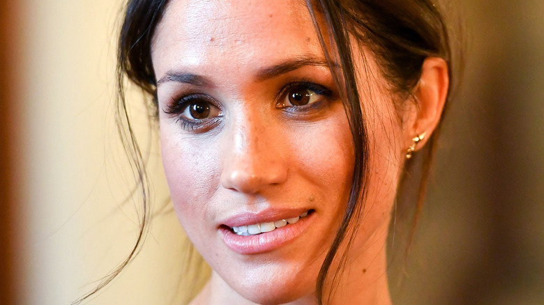 Meghan Markle smiling at an event.