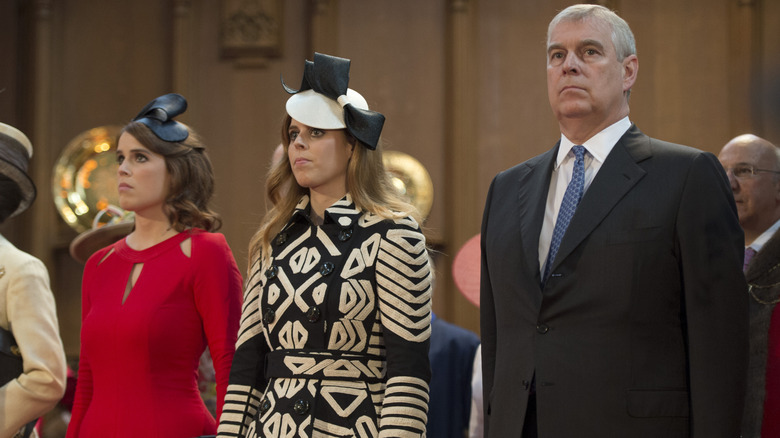 Prince Andrew, Princess Beatrice, and Princess Eugenie frowning