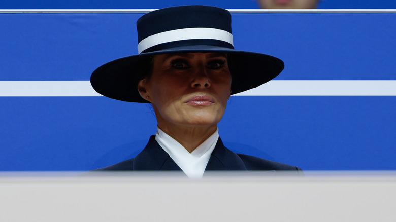 Melania Trump looking serious under her big hat