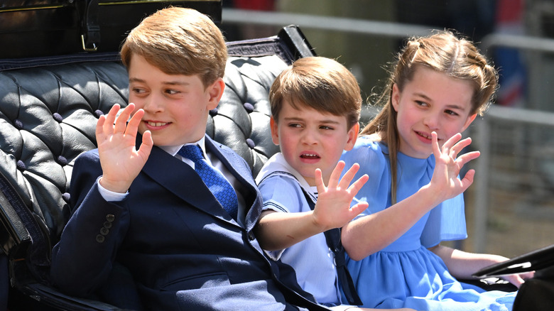 Princess Charlotte riding in a carriage with her two brothers