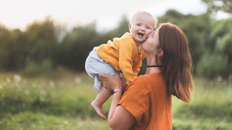 Mother kissing baby