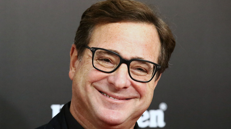 Bob Saget smiling on the red carpet