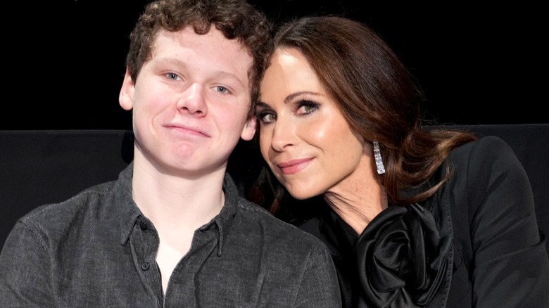 Henry Driver and Minnie Driver seated together smiling.