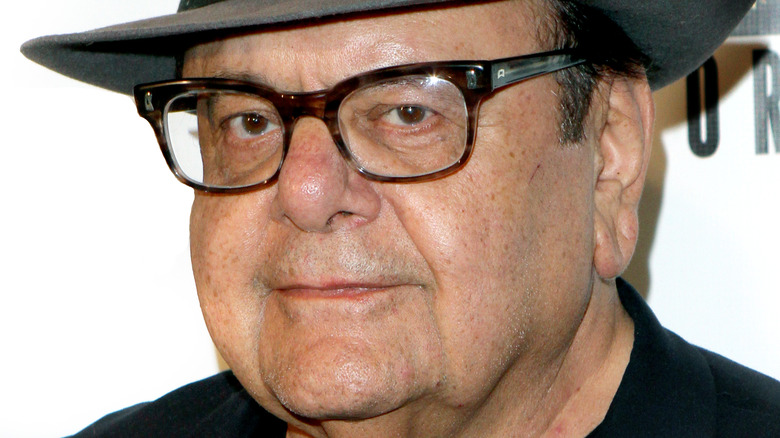 Paul Sorvino smiling in glasses and a hat