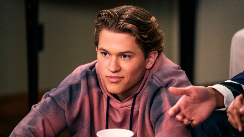 Deacon Phillippe as Parker in a purple tie-dye hoodie, from Never Have I Ever