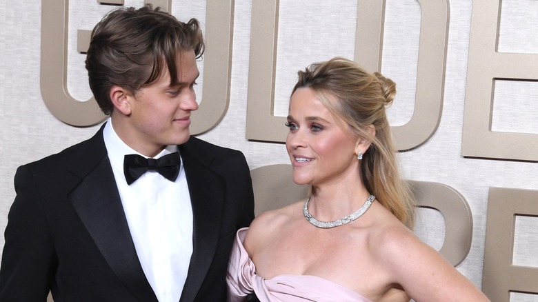 Deacon Phillippe smiling at Reese Witherspoon moments after fixing her hair on the Golden Globes carpet