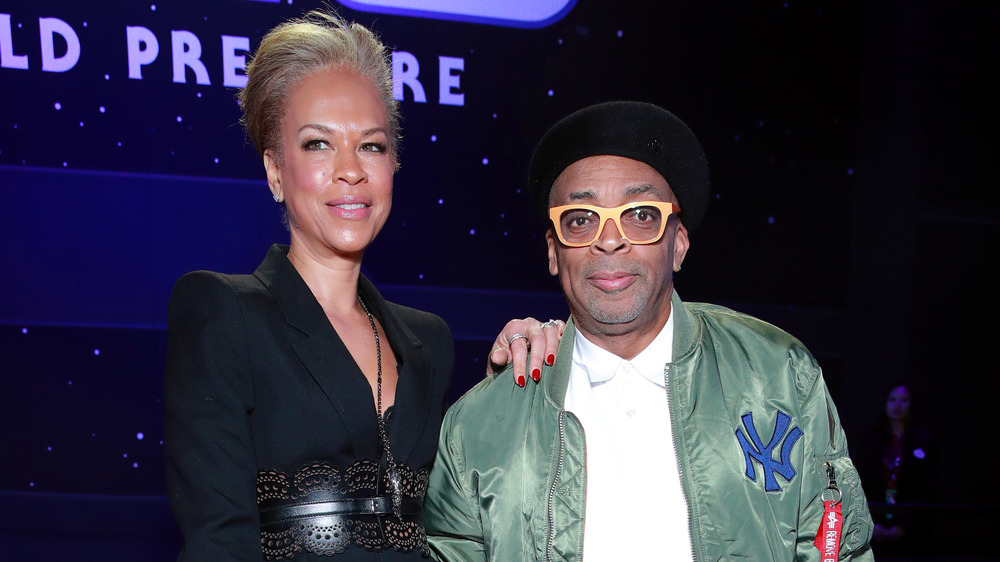 Spike Lee, Tonya Lewis Lee posing at event