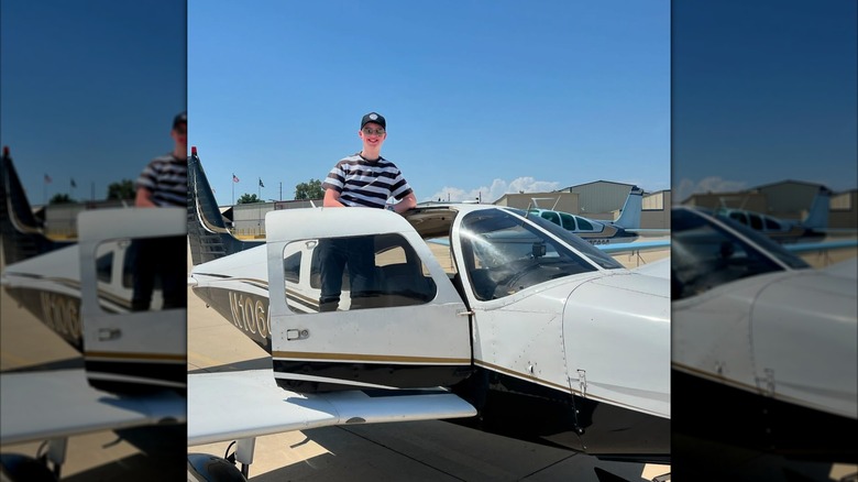 Iain Armitage standing in a plane