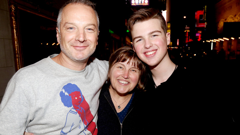 Ian Armitage smiling for photos with his parents