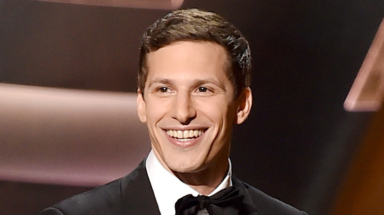 Andy Samberg smiles onstage
