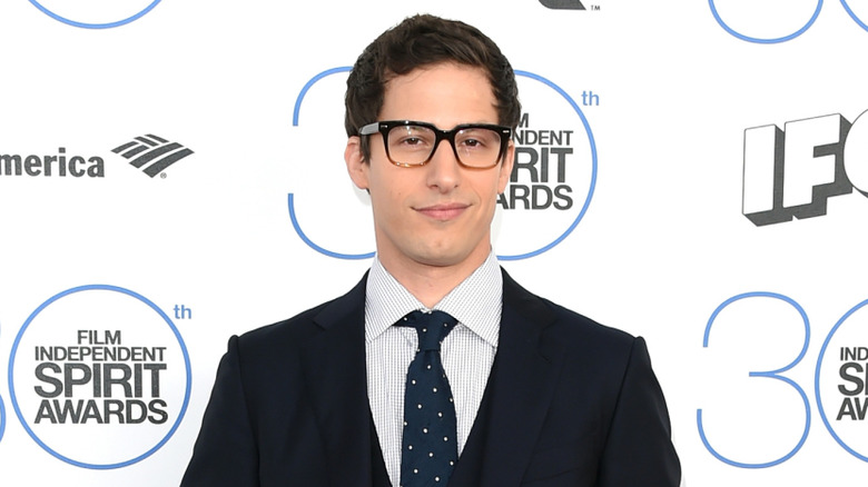Andy Samberg smiles at an event
