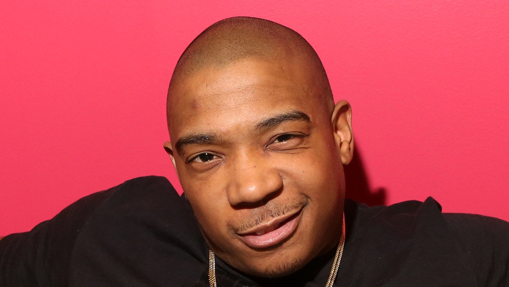 Ja Rule poses confidently on a sofa