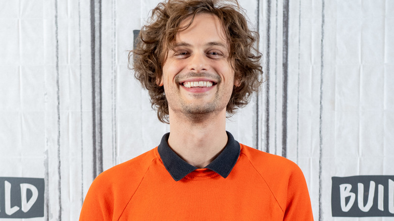 Matthew Gray Gubler in an orange sweater