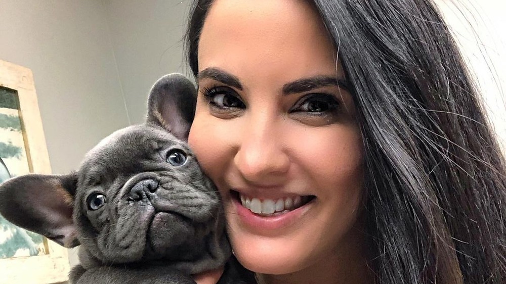 Jackie Duenas poses with a puppy
